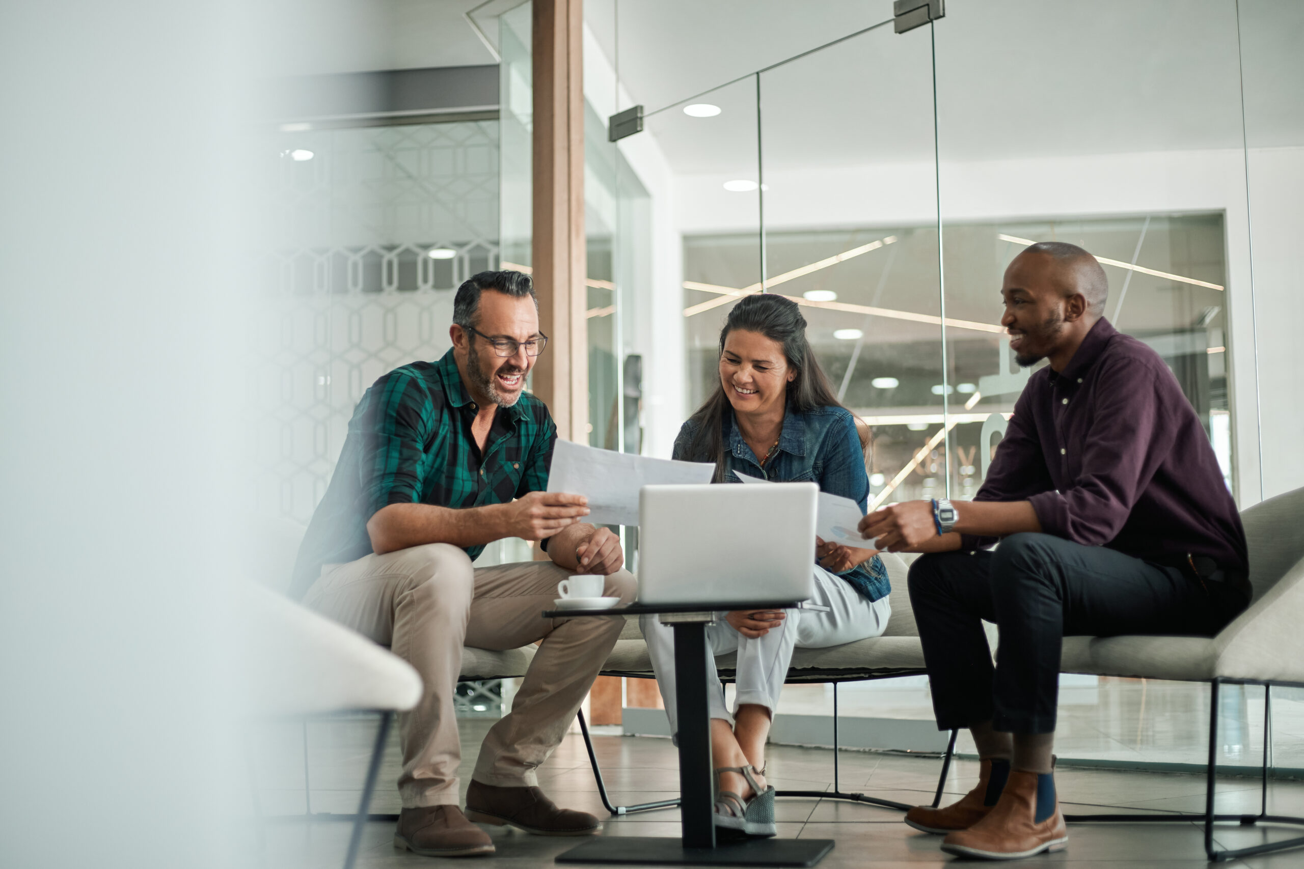 Casual meeting of smiling diverse business team analyzing financ